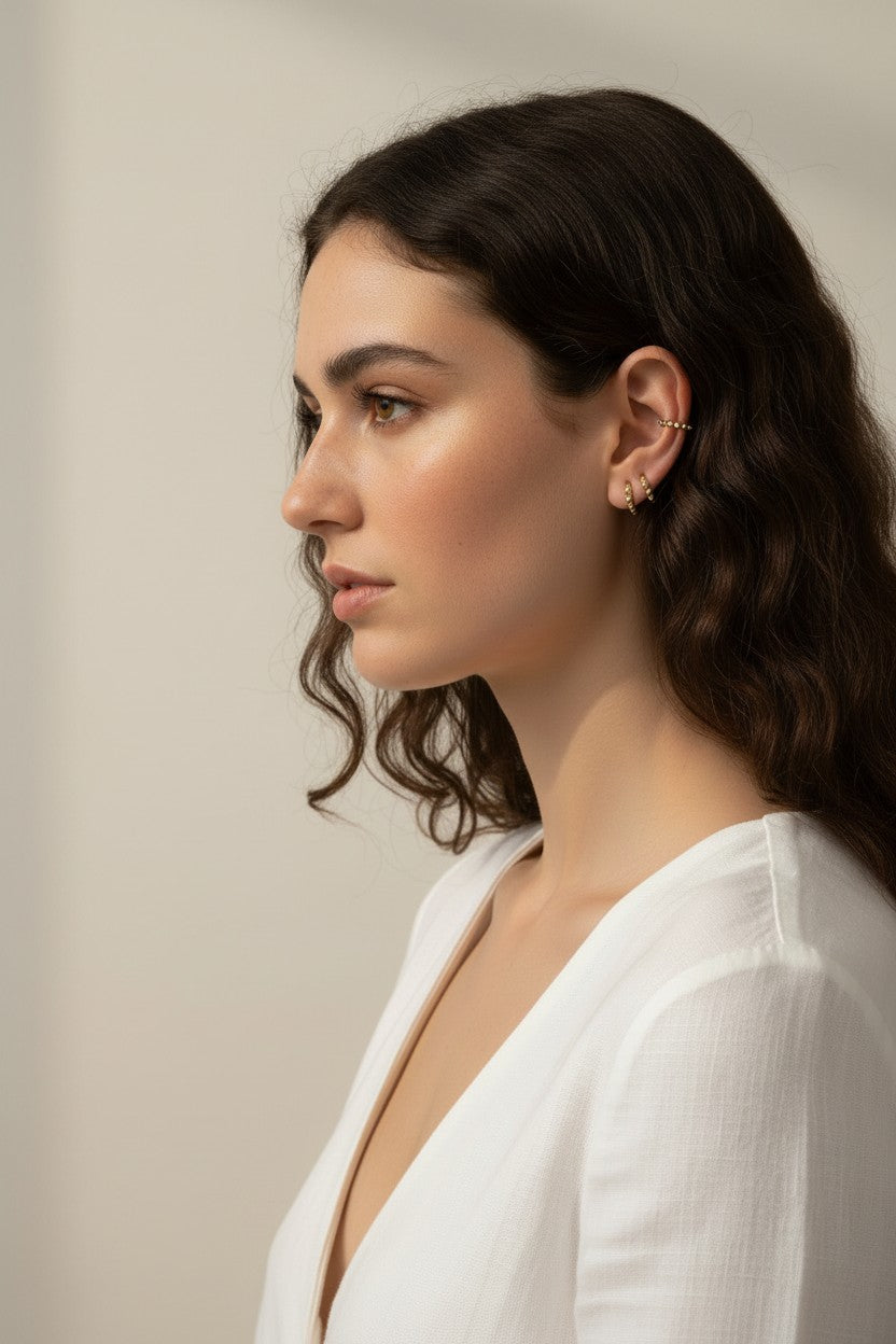 gold beaded huggie hoops, small gold hoop earrings, stacked ear look, beaded hoop earrings, layered earring set, gold huggie hoops on model, dainty gold hoops, curated ear stack