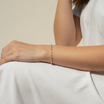 CZ tennis bracelet on model, baguette round cut bracelet wrist shot, cubic zirconia bracelet lifestyle, sparkly tennis bracelet on wrist, gold CZ bracelet on model, matching tennis jewelry, dainty tennis bracelet, statement CZ bracelet photo