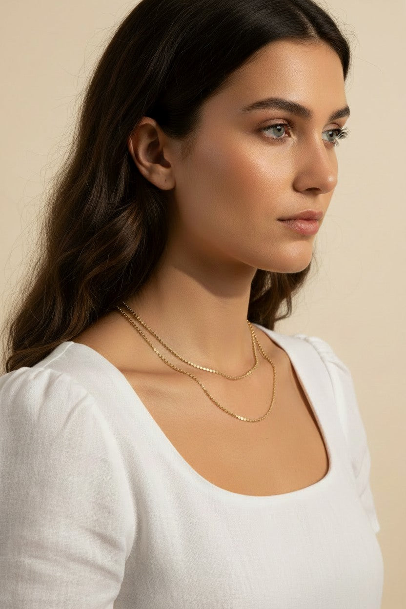 layered gold necklace set worn, double chain necklace styled, gold chain layering set fit, minimalist layered necklace lifestyle photo, disc chain and cable chain necklace, gold necklace stack close-up