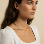 layered gold necklace set worn, double chain necklace styled, gold chain layering set fit, minimalist layered necklace lifestyle photo, disc chain and cable chain necklace, gold necklace stack close-up