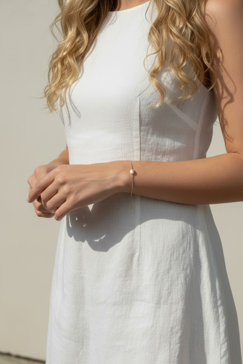 gold pearl bracelet on wrist, freshwater pearl chain bracelet worn, dainty pearl bracelet lifestyle photo, minimalist pearl jewelry styled, delicate gold bracelet fit, pearl bracelet close-up
