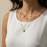 layered gemstone necklace, multicolor gemstone chain, emerald pendant necklace, gold layered necklace set, dainty gemstone necklace, colorful chain necklace, green stone pendant, layered necklace on-model