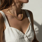 gold rope chain on model, twisted rope chain necklace, classic gold chain necklace, collarbone length chain, everyday gold necklace, layering chain necklace, unisex gold chain, medium rope chain, gold chain with lobster clasp, timeless gold jewelry, women’s gold rope chain, minimalist gold necklace
