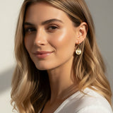 sunburst disc earrings, gold drop earrings on model, heart pavé earrings, huggie hoop drop earrings, textured gold earrings, statement drop earrings, sparkle disc earrings, everyday gold earrings