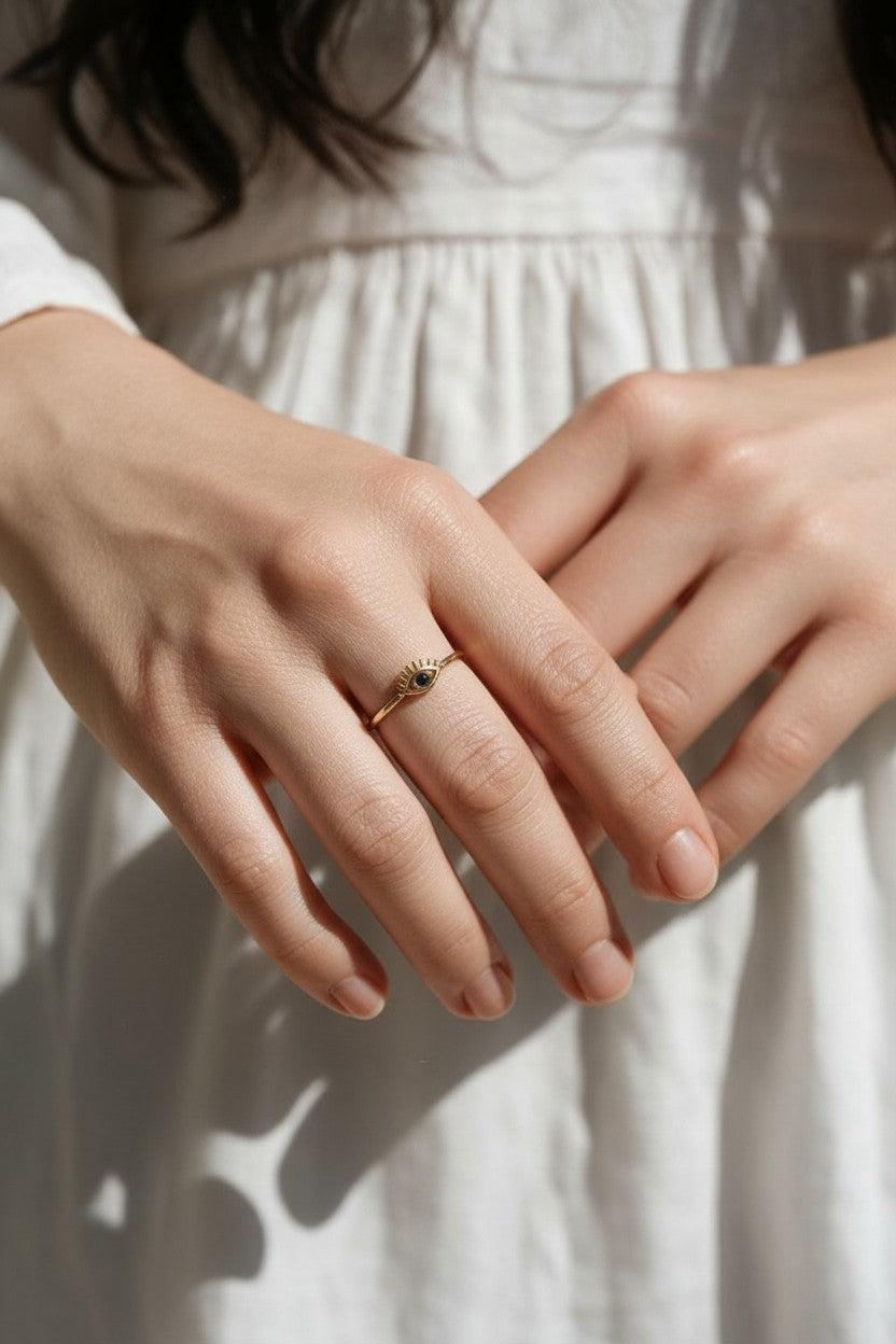 eye ring on model, evil eye ring on hand, dainty gold eye ring, blue stone eye ring lifestyle, minimalist stacking ring, lash eye ring styled, protective eye jewelry