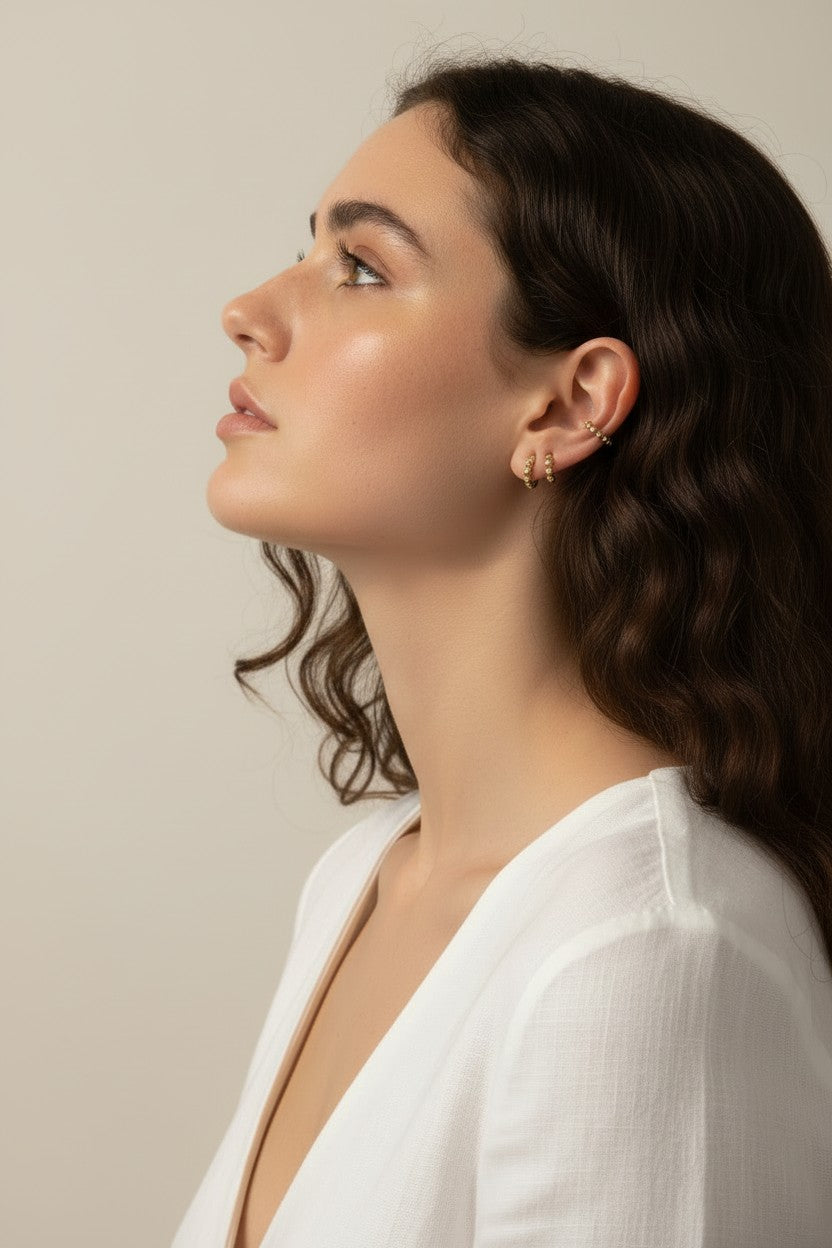 gold beaded huggie hoops, small gold hoop earrings, stacked ear look, beaded hoop earrings, layered earring set, gold huggie hoops on model, dainty gold hoops, curated ear stack