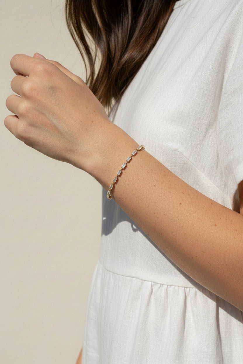 CZ tennis bracelet on model, baguette round cut bracelet wrist shot, cubic zirconia bracelet lifestyle, sparkly tennis bracelet on wrist, gold CZ bracelet on model, matching tennis jewelry, dainty tennis bracelet, statement CZ bracelet photo