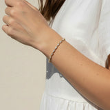 CZ tennis bracelet on model, baguette round cut bracelet wrist shot, cubic zirconia bracelet lifestyle, sparkly tennis bracelet on wrist, gold CZ bracelet on model, matching tennis jewelry, dainty tennis bracelet, statement CZ bracelet photo