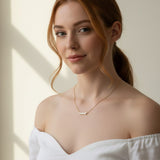 baguette bar necklace on model, clear baguette pendant necklace, gold bar necklace with stones, delicate layering necklace, minimalist sparkle necklace, baguette pendant on collarbone, gold chain bar necklace, dainty statement necklace