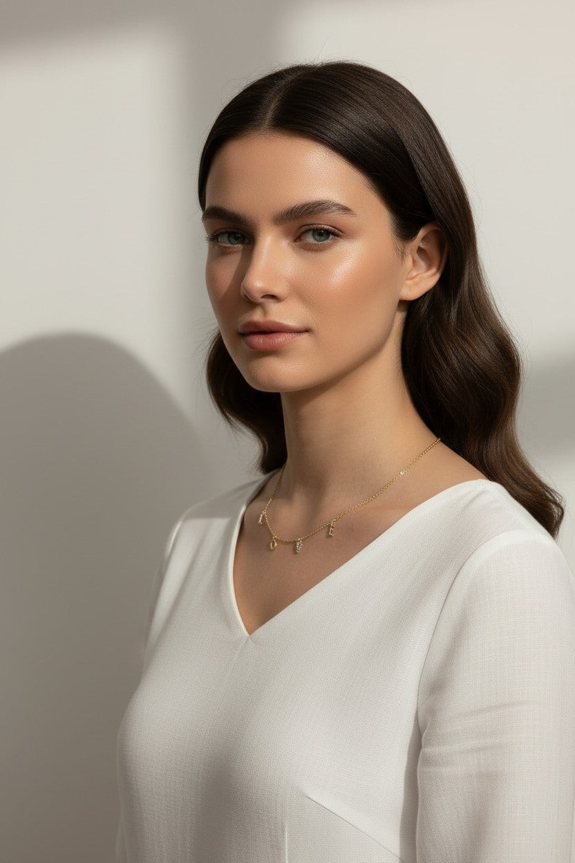love necklace on model, letter charm necklace lifestyle, dangling love pendant styled, pavé letter necklace worn, gold love charm necklace, sentimental jewelry gift, word necklace on neck, cubic zirconia letter necklace
