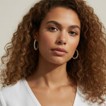 pearl hoop earrings worn, pearl earrings on model multiple hairstyles, classic pearl hoops lifestyle photo, wedding pearl earrings styled, freshwater pearl hoops fit, timeless pearl earrings close-up