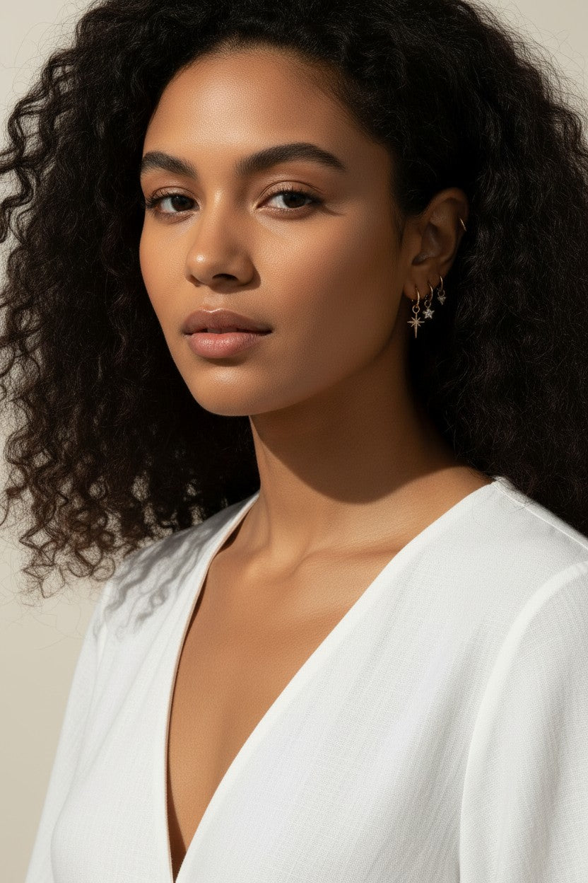 celestial charm hoop earrings worn, star and north star earring styled, layered ear stack gold, charm hoop earrings lifestyle photo, mix and match earring charms fit, gold star earring close-up