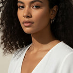 celestial charm hoop earrings worn, star and north star earring styled, layered ear stack gold, charm hoop earrings lifestyle photo, mix and match earring charms fit, gold star earring close-up