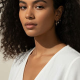 celestial charm hoop earrings worn, star and north star earring styled, layered ear stack gold, charm hoop earrings lifestyle photo, mix and match earring charms fit, gold star earring close-up