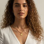 gold coin pendant necklace worn, curb chain medallion necklace styled, vintage coin necklace fit, engraved coin pendant lifestyle photo, gold medallion necklace close-up, classical figure coin necklace