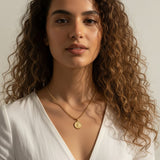 gold coin pendant necklace worn, curb chain medallion necklace styled, vintage coin necklace fit, engraved coin pendant lifestyle photo, gold medallion necklace close-up, classical figure coin necklace