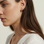 chunky gold hoop earrings, dome hoop earrings on model, puffy gold earrings, statement gold earrings, sculptural gold hoops, minimalist chunky earrings, high shine gold earrings, gold earrings close-up