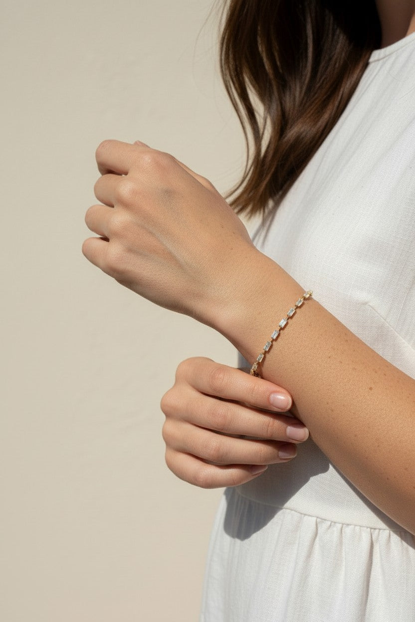 CZ tennis bracelet on model, baguette round cut bracelet wrist shot, cubic zirconia bracelet lifestyle, sparkly tennis bracelet on wrist, gold CZ bracelet on model, matching tennis jewelry, dainty tennis bracelet, statement CZ bracelet photo