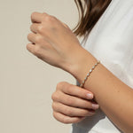 CZ tennis bracelet on model, baguette round cut bracelet wrist shot, cubic zirconia bracelet lifestyle, sparkly tennis bracelet on wrist, gold CZ bracelet on model, matching tennis jewelry, dainty tennis bracelet, statement CZ bracelet photo