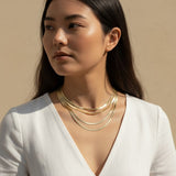 herringbone chain layered necklaces, gold herringbone layering set, multi-strand herringbone necklace, layered gold chain on model, 18k gold overlay chain set, herringbone choker and necklace, layered necklace styling, gold chain layering inspiration
