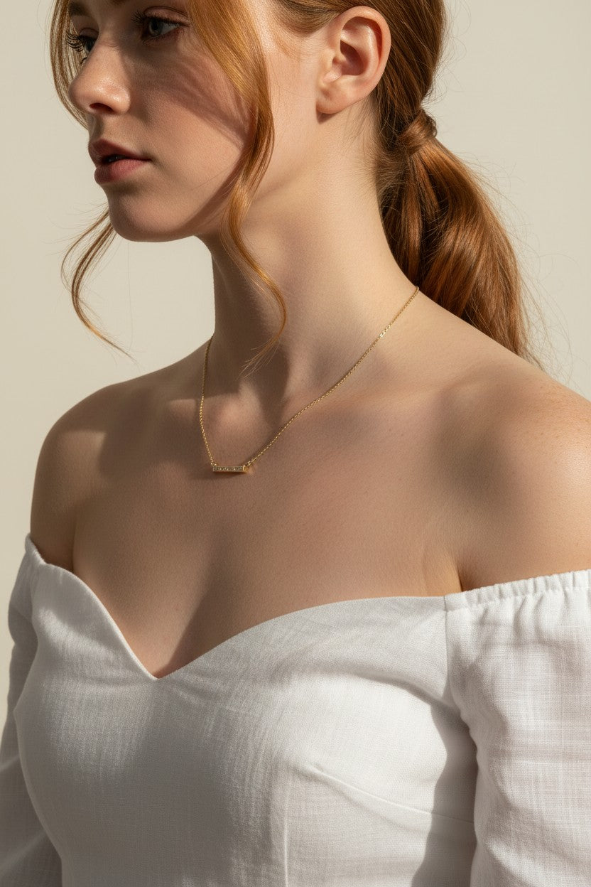 baguette bar necklace on model, clear baguette pendant necklace, gold bar necklace with stones, delicate layering necklace, minimalist sparkle necklace, baguette pendant on collarbone, gold chain bar necklace, dainty statement necklace
