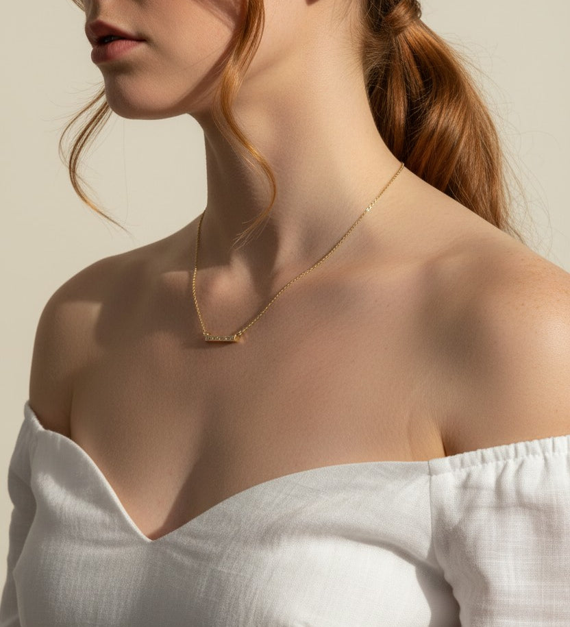 baguette bar necklace on model, clear baguette pendant necklace, gold bar necklace with stones, delicate layering necklace, minimalist sparkle necklace, baguette pendant on collarbone, gold chain bar necklace, dainty statement necklace