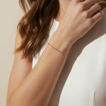 CZ bar bracelet on model, cubic zirconia bracelet wrist shot, gold bracelet close-up, sparkly bar bracelet on model, dainty CZ bracelet, layering bracelet lifestyle, gold overlay bracelet on wrist, minimalist CZ jewelry