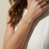 CZ bar bracelet on model, cubic zirconia bracelet wrist shot, gold bracelet close-up, sparkly bar bracelet on model, dainty CZ bracelet, layering bracelet lifestyle, gold overlay bracelet on wrist, minimalist CZ jewelry