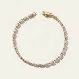 baguette CZ tennis bracelet, all baguette cubic zirconia bracelet, gold baguette bracelet flat lay, art deco tennis bracelet, sparkly baguette bracelet, emerald cut CZ bracelet, tennis bracelet clasp detail, uniform stone tennis bracelet