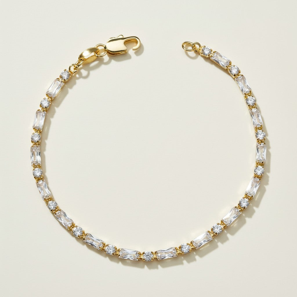 CZ tennis bracelet, baguette round cut bracelet, cubic zirconia tennis bracelet, matching tennis jewelry set, gold tennis bracelet detail, sparkly CZ bracelet flat lay, prong set CZ bracelet, tennis bracelet clasp detail