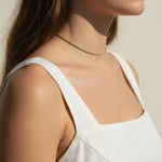 CZ tennis choker on model, baguette round cut necklace, sparkly choker close-up, stainless steel tennis necklace, cubic zirconia choker on model, statement choker necklace, layering CZ necklace, glamorous choker photo