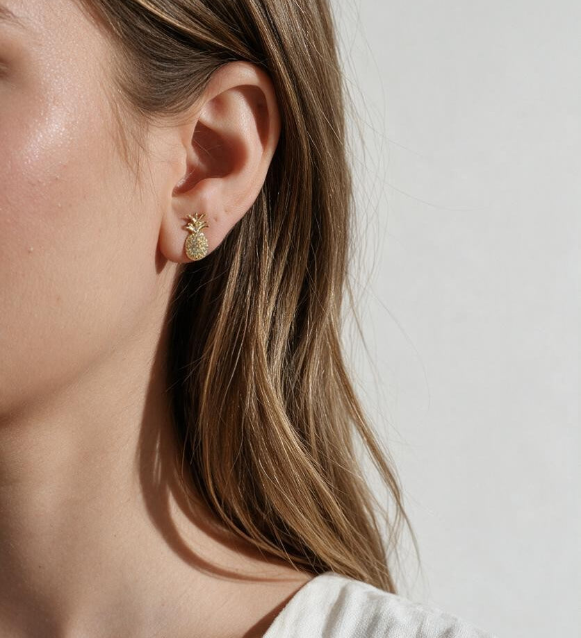pineapple stud earrings, pavé pineapple earrings, gold pineapple studs, tropical stud earrings, crystal fruit earrings, dainty novelty earrings, summer stud earrings, pineapple earrings on model