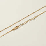 layered satellite necklace flat lay, three strand necklace clasp, cascading gold necklace construction, beaded chain necklace detail, 18k gold satellite chain, graduated necklace flat lay, multi strand necklace clasp detail, delicate layered gold necklace