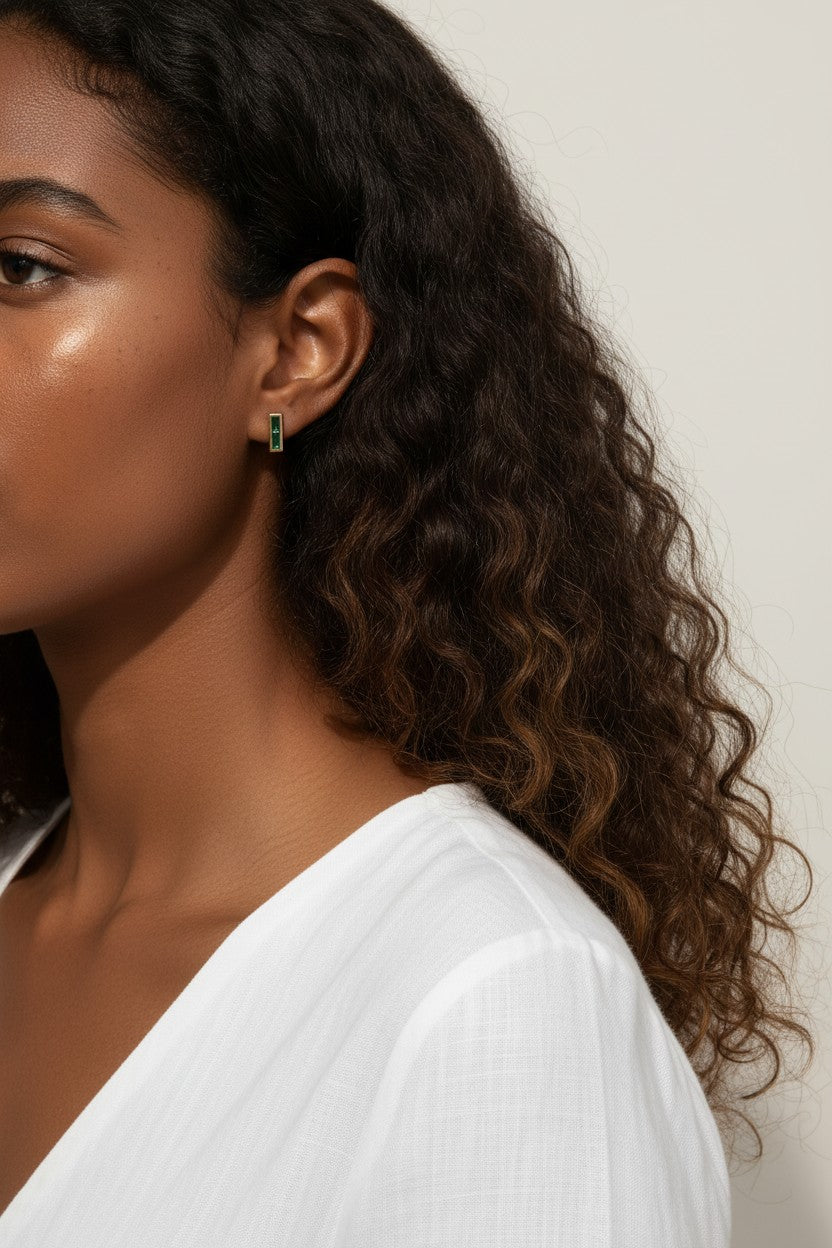 gold bar stud earrings on model, baguette stud earrings worn, emerald bar earrings styled, black baguette stud earrings, clear crystal bar earrings on ear, geometric stud earrings lifestyle, minimalist gold studs worn
