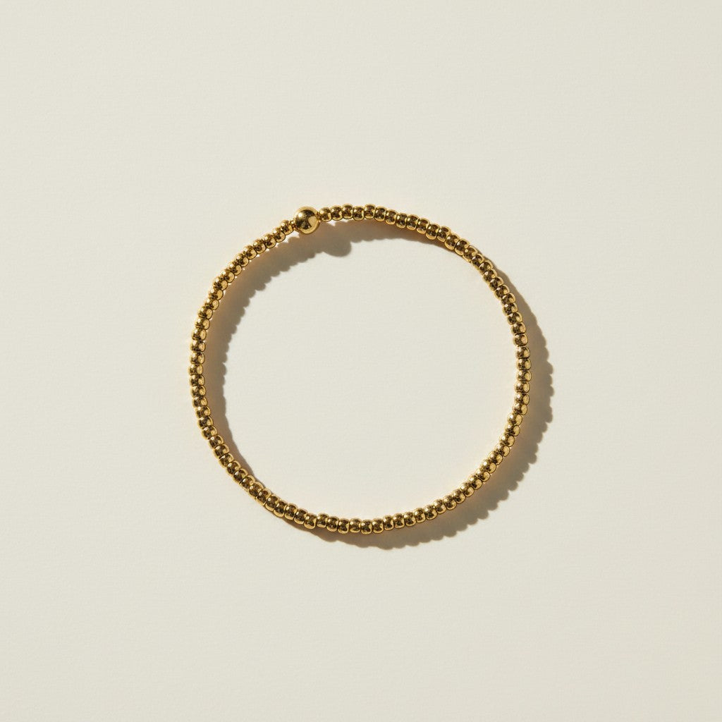 gold beaded stretch bracelet, gold bead bracelet, stretch bracelet gold, minimalist beaded bracelet, stackable gold bracelet, dainty gold bead bracelet, no clasp bracelet, layering bracelet flat lay