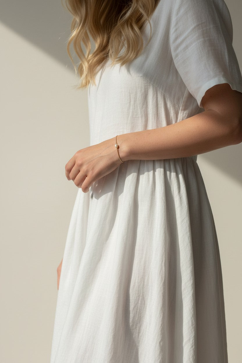gold pearl bracelet on wrist, freshwater pearl chain bracelet worn, dainty pearl bracelet lifestyle photo, minimalist pearl jewelry styled, delicate gold bracelet fit, pearl bracelet close-up