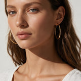 large thin gold hoop earrings on model, big gold hoops, thin wire hoop earrings, endless hoop earrings, classic gold hoops, lightweight large hoops, minimalist hoop earrings, everyday gold hoops, statement hoops, sleeper hoops, summer hoop earrings, gift for her