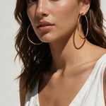 large thin gold hoop earrings on model, big gold hoops, thin wire hoop earrings, endless hoop earrings, classic gold hoops, lightweight large hoops, minimalist hoop earrings, everyday gold hoops, statement hoops, sleeper hoops, summer hoop earrings, gift for her