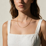 fine gold box chain necklace on model, thin gold chain necklace, dainty gold necklace, delicate box chain, layering chain necklace, collarbone necklace, minimalist gold necklace, everyday gold chain, simple gold chain necklace, lightweight gold necklace, summer linen style jewelry, gift for her