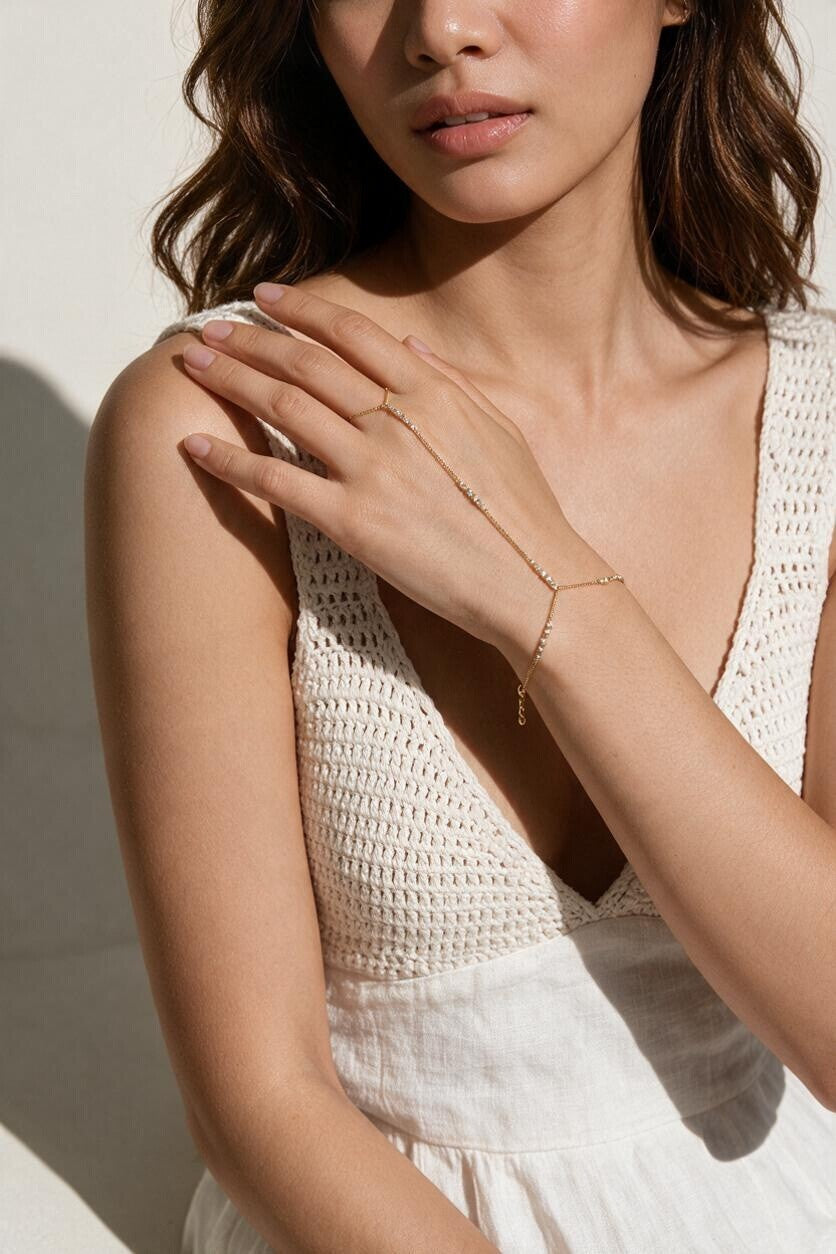 gold hand chain bracelet on model, slave bracelet, finger ring bracelet, hand harness jewelry, crystal hand chain, bridal hand chain, bracelet with ring attached, dainty gold hand chain, delicate hand jewelry, party hand jewelry, wedding hand chain, women’s hand chain