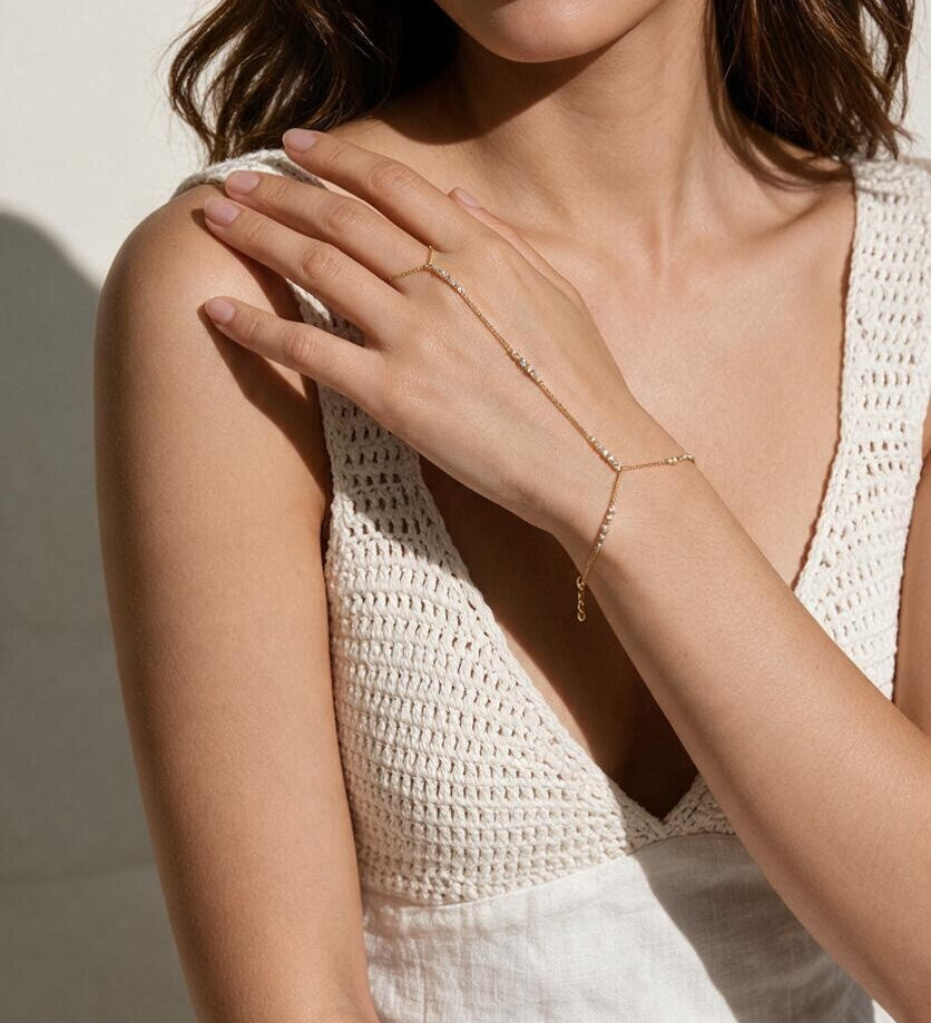gold hand chain bracelet on model, slave bracelet, finger ring bracelet, hand harness jewelry, crystal hand chain, bridal hand chain, bracelet with ring attached, dainty gold hand chain, delicate hand jewelry, party hand jewelry, wedding hand chain, women’s hand chain