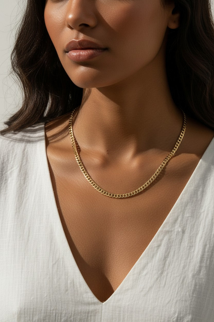 curb chain necklace on model, gold curb link necklace, classic chain necklace styled, flat link necklace worn, everyday gold necklace, polished chain necklace, layering necklace, curb chain necklace lifestyle