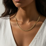 curb chain necklace on model, gold curb link necklace, classic chain necklace styled, flat link necklace worn, everyday gold necklace, polished chain necklace, layering necklace, curb chain necklace lifestyle