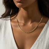 curb chain necklace on model, gold curb link necklace, classic chain necklace styled, flat link necklace worn, everyday gold necklace, polished chain necklace, layering necklace, curb chain necklace lifestyle