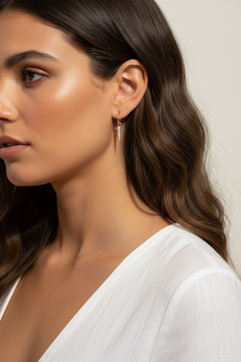 CZ spear charm worn, gold hoop with charm styled, interchangeable earring charm fit, cubic zirconia charm on model, customizable hoop earring lifestyle photo, gold spear charm close-up