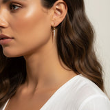 CZ spear charm worn, gold hoop with charm styled, interchangeable earring charm fit, cubic zirconia charm on model, customizable hoop earring lifestyle photo, gold spear charm close-up