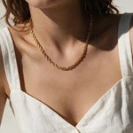 gold rope chain on model, twisted rope chain necklace, classic gold chain necklace, collarbone length chain, everyday gold necklace, layering chain necklace, unisex gold chain, medium rope chain, gold chain with lobster clasp, timeless gold jewelry, women’s gold rope chain, minimalist gold necklace