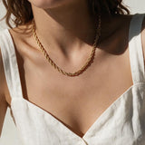 gold rope chain on model, twisted rope chain necklace, classic gold chain necklace, collarbone length chain, everyday gold necklace, layering chain necklace, unisex gold chain, medium rope chain, gold chain with lobster clasp, timeless gold jewelry, women’s gold rope chain, minimalist gold necklace
