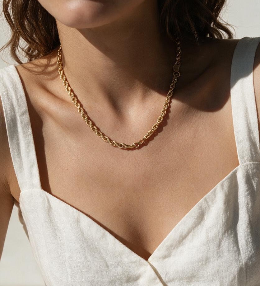 gold rope chain on model, twisted rope chain necklace, classic gold chain necklace, collarbone length chain, everyday gold necklace, layering chain necklace, unisex gold chain, medium rope chain, gold chain with lobster clasp, timeless gold jewelry, women’s gold rope chain, minimalist gold necklace