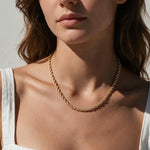 gold rope chain on model, twisted rope chain necklace, classic gold chain necklace, collarbone length chain, everyday gold necklace, layering chain necklace, unisex gold chain, medium rope chain, gold chain with lobster clasp, timeless gold jewelry, women’s gold rope chain, minimalist gold necklace